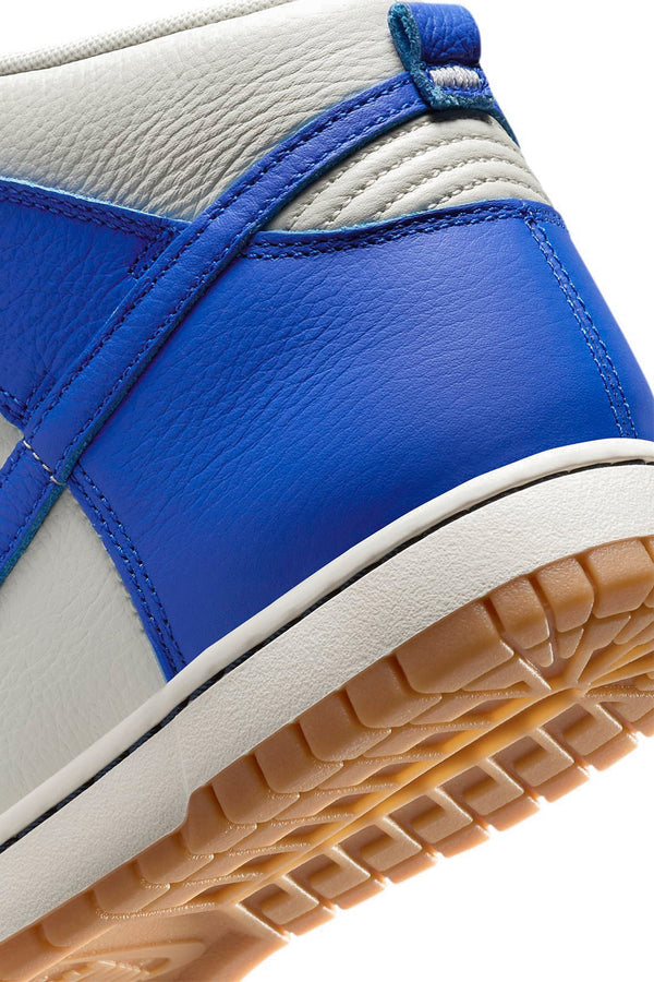 Close-up of a blue and white sneaker with a tan sole